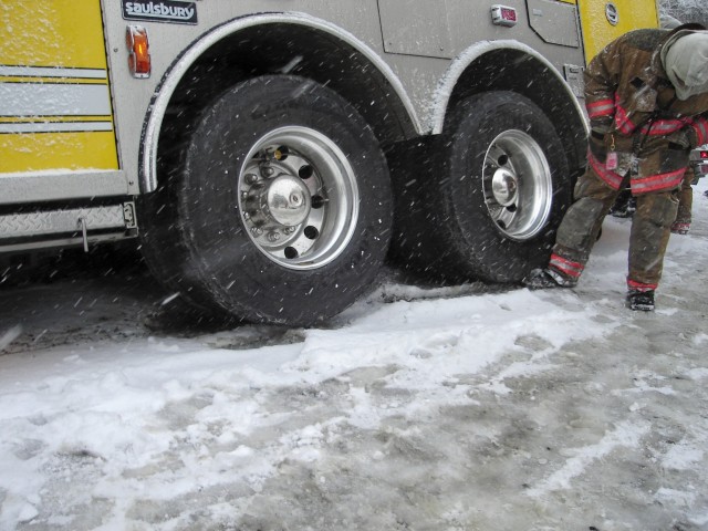 Lt. Carroll putting his boots under the tires